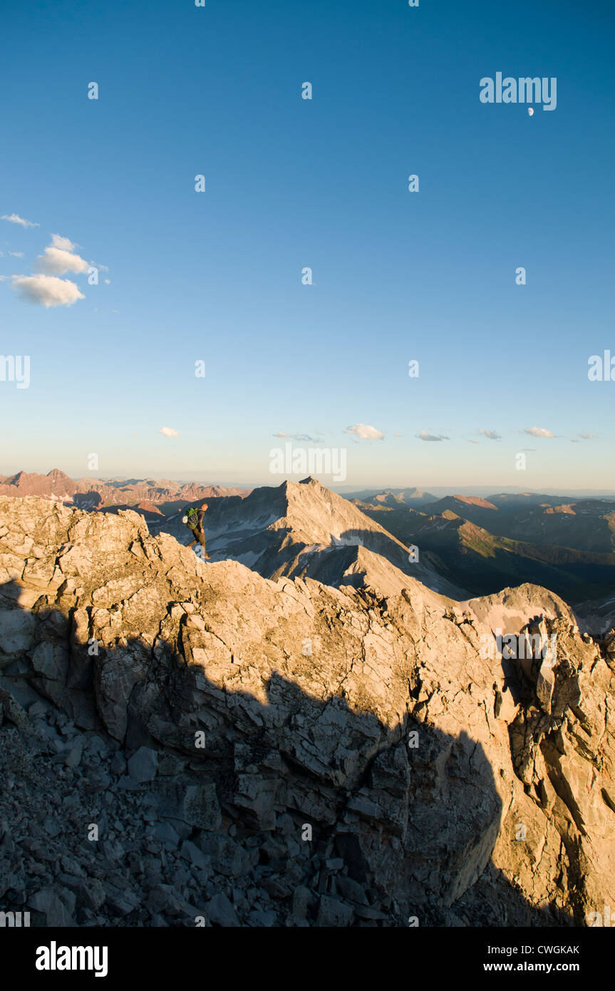 A man hiking along rocky ridge in the White River National Forest ...