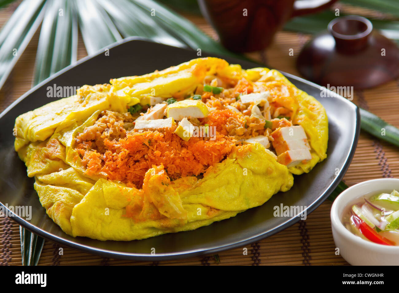 Stir fried bean sprout,tofu,coconut wrapped in omelet [Thai 's cuisine