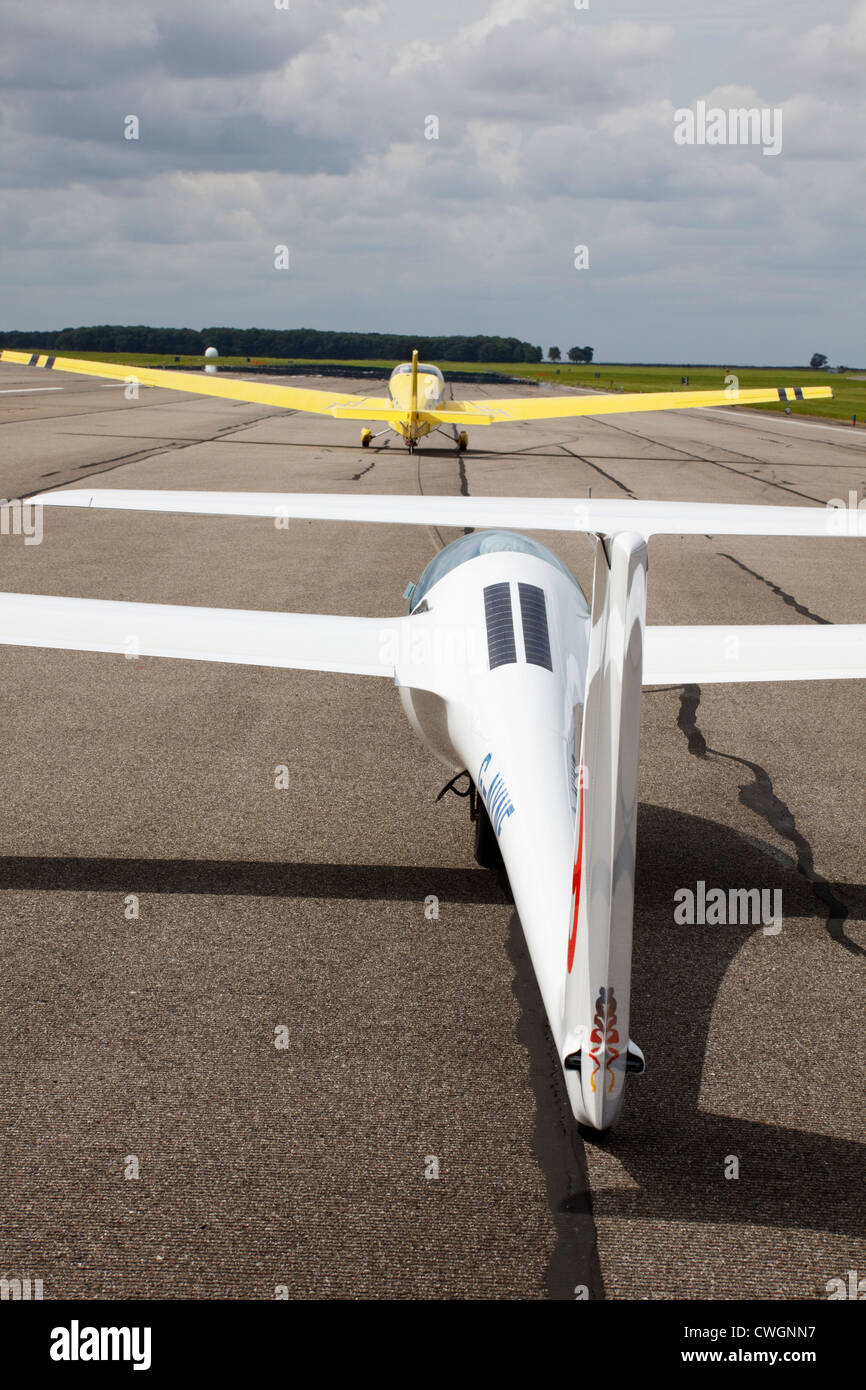 Schleicher ASG-29E glider on aerotow behind a Scheibe SF25C Turbo Falke on the runway Stock Photo
