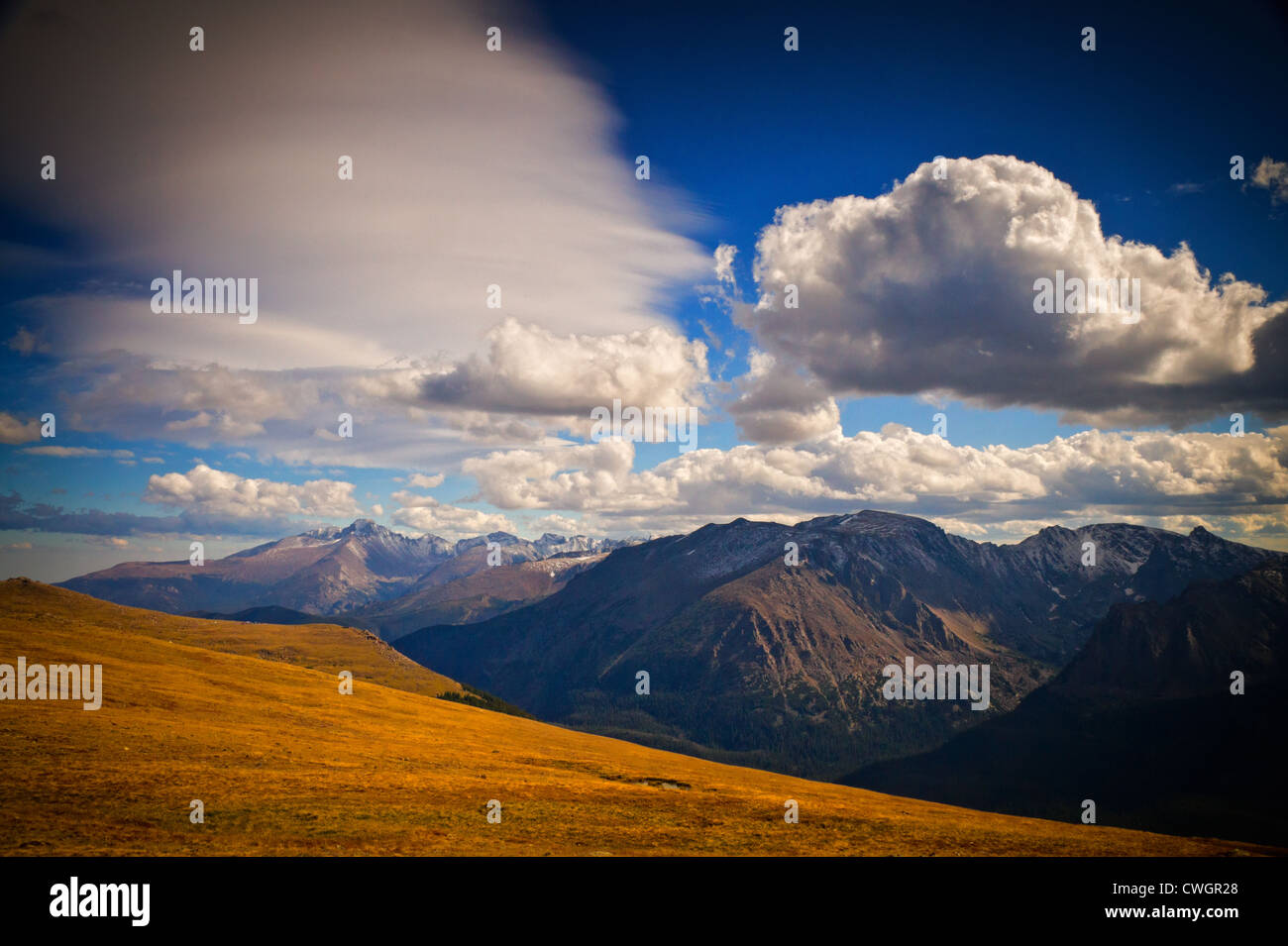 Longs Peak touches the clouds along the alpine tundra areas of Rocky Mountain National Park, Colorado on beautiful Fall day Stock Photo