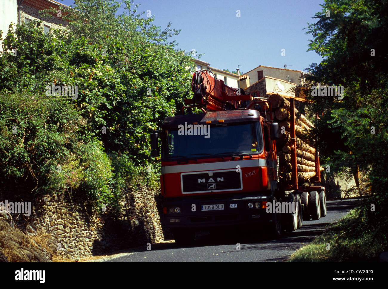 St Marsal France Languedoc-Roussillon Lorry Carying Tree Logs On Narrow Road Stock Photo