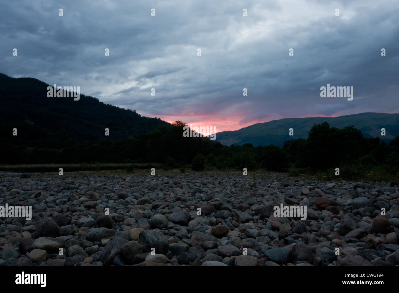 River at sunset, dark landscape with red clouds Stock Photo