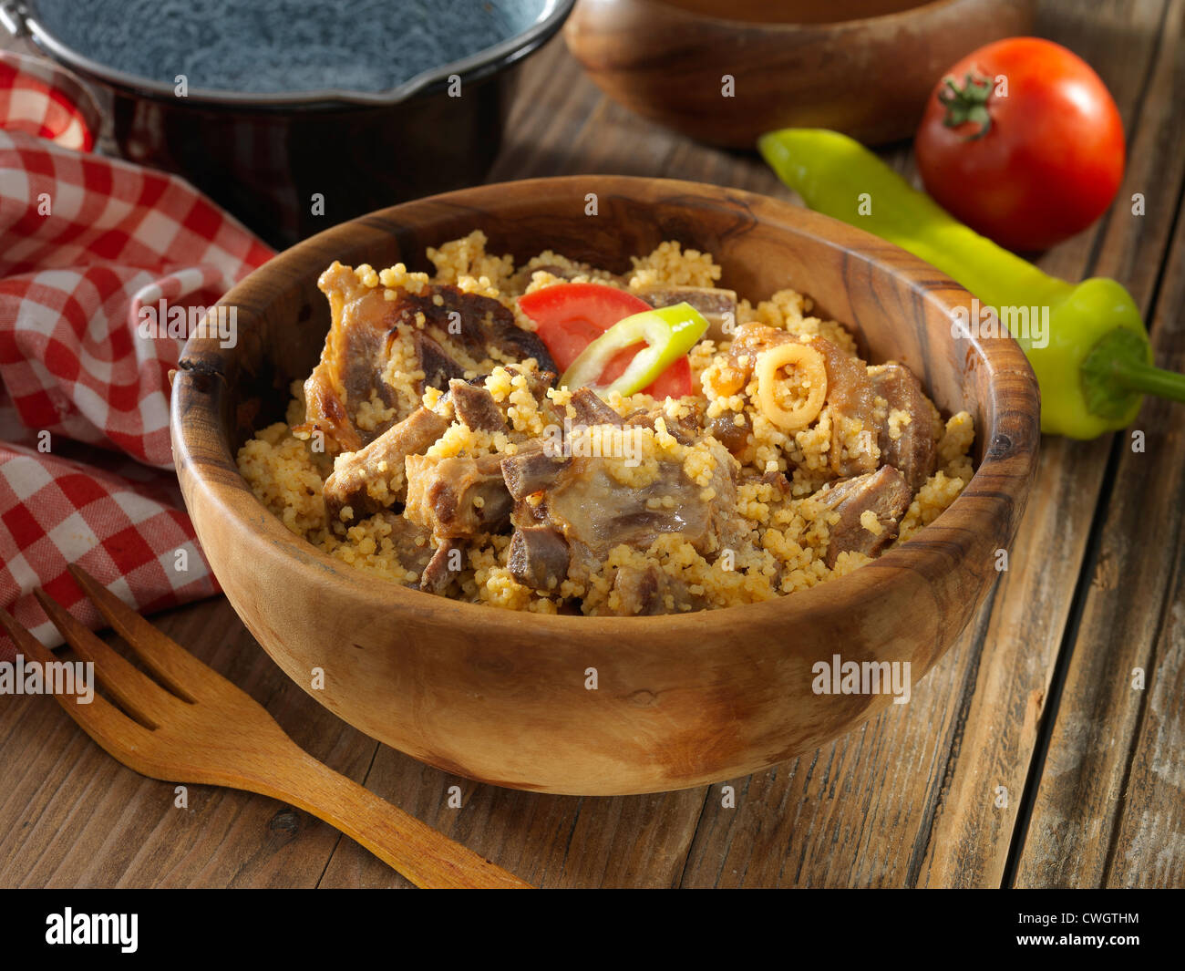 sheep meat with millet in rustic plate Stock Photo