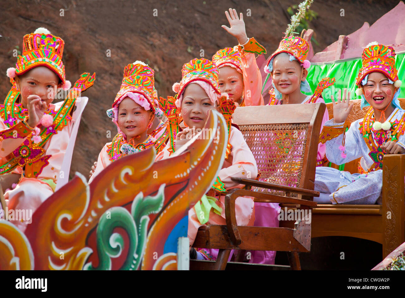 Girls in costume are part of a PROCESSION for young men entering a Buddhist monastery in KENGTUNG  - MYANMAR Stock Photo