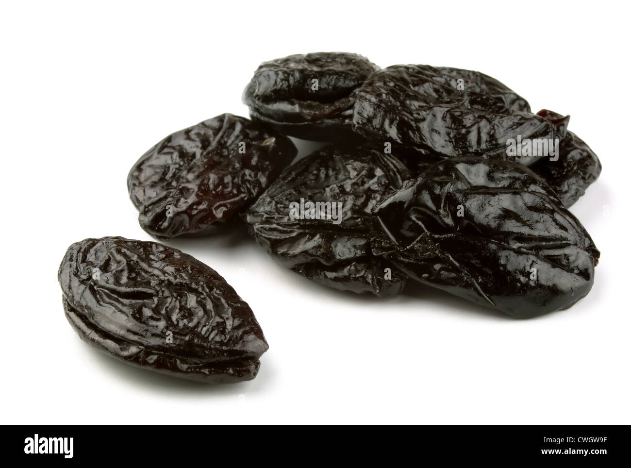 group of dried prunes on white Stock Photo