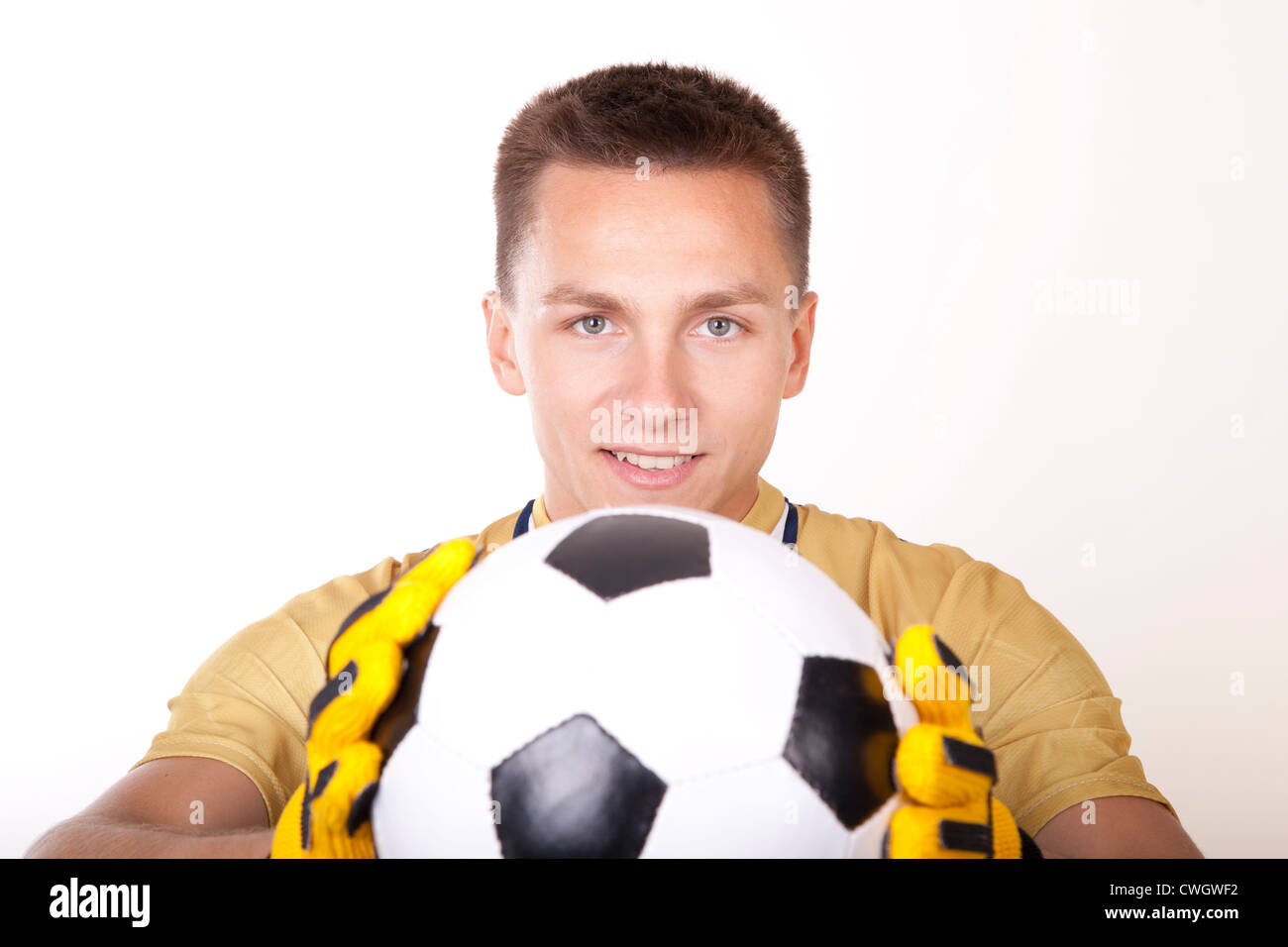 Young man goalkeeper holding a ball. Stock Photo