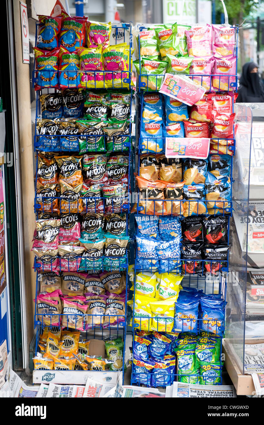 many packets of potato crisps in a variety of flavours for sale on display Stock Photo