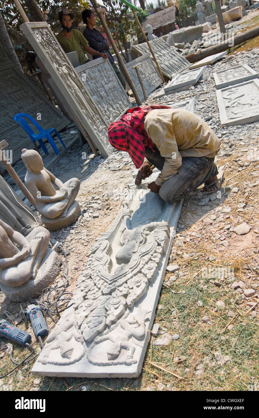 Horizontal portrait of a stone mason working on a marble freize in Kakoah stonemasons village near Phnom Santuk in Cambodia Stock Photo