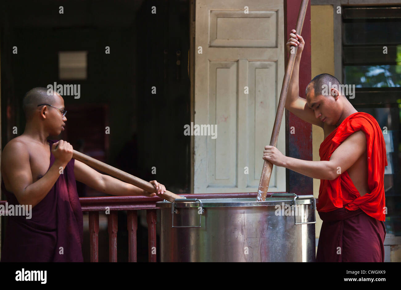 BUDDHIST MONKS are fed each day at 11 AM at the MAHAGANDAYON MONASTERY - MANDALAY, MYANMAR Stock Photo