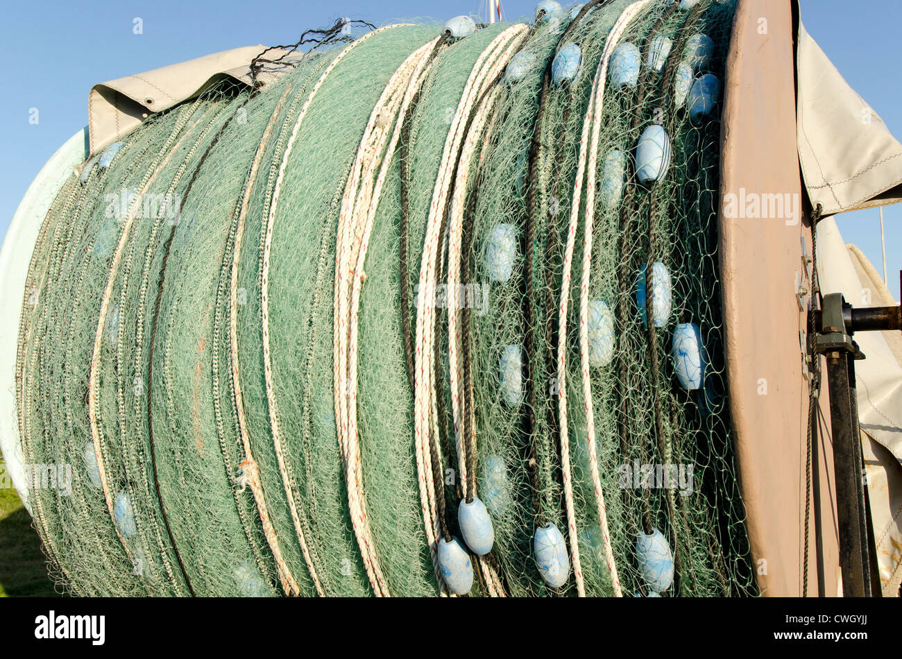Monofilament trawler fishing net and floats rolled up for storage out of water, Wanchese North Carolina Outer Banks Stock Photo