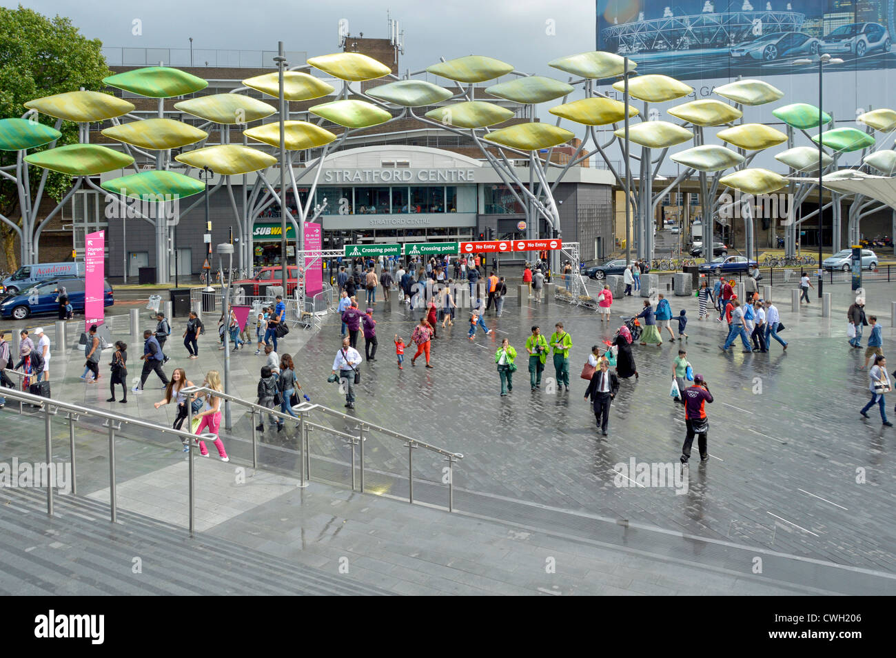 Stratford Plaza on a wet summers day during London 2012 Olympics with Shoal leaf decorations beyond Stock Photo