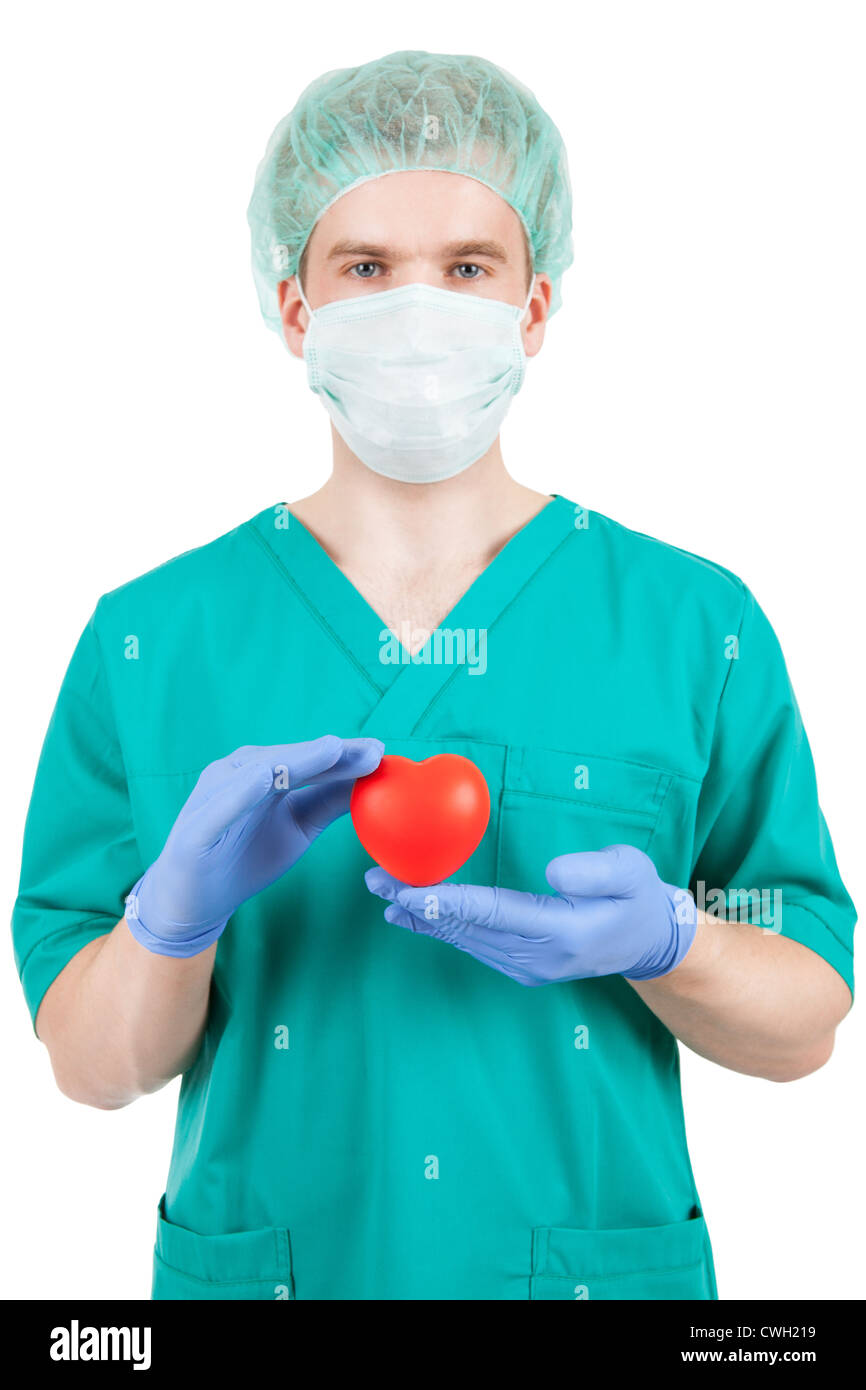 Doctor in mask with heart in his hands - studio shot Stock Photo - Alamy