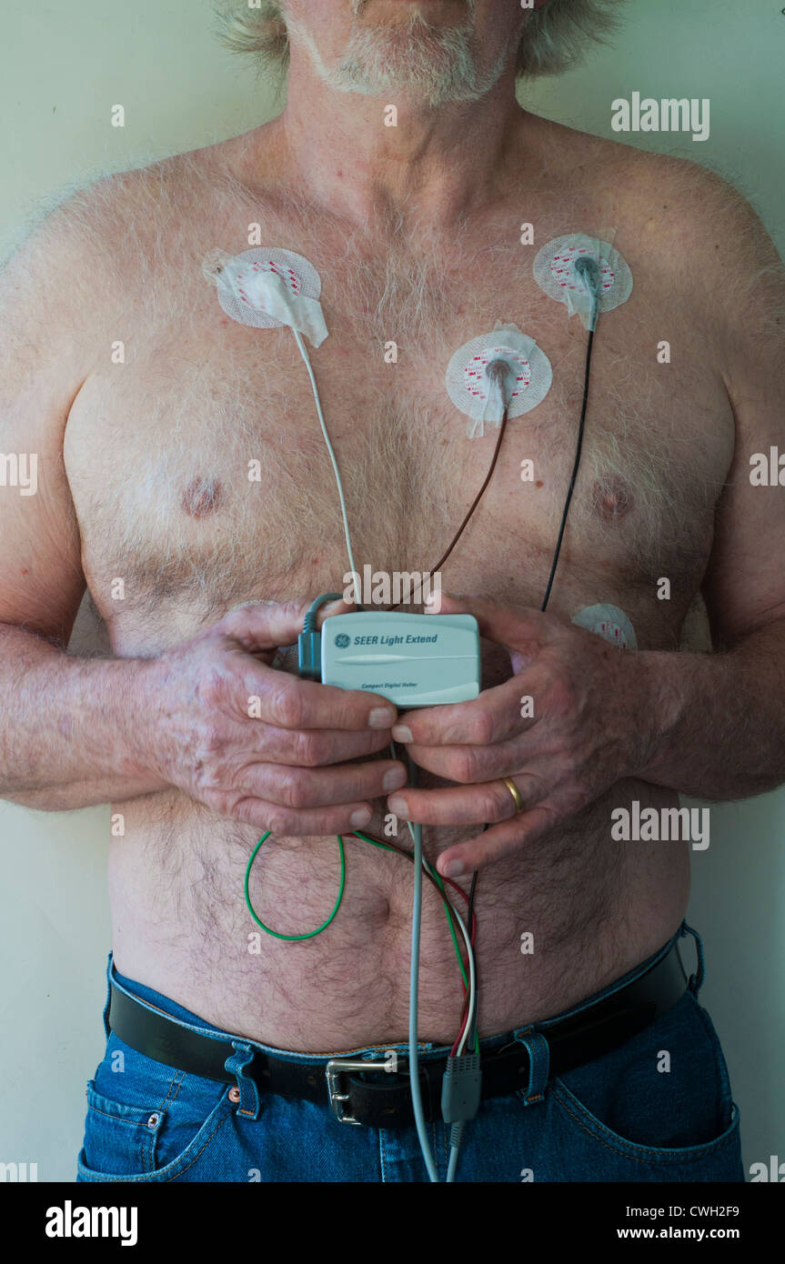 Elderly man wearing a Holter heart monitor Stock Photo Alamy