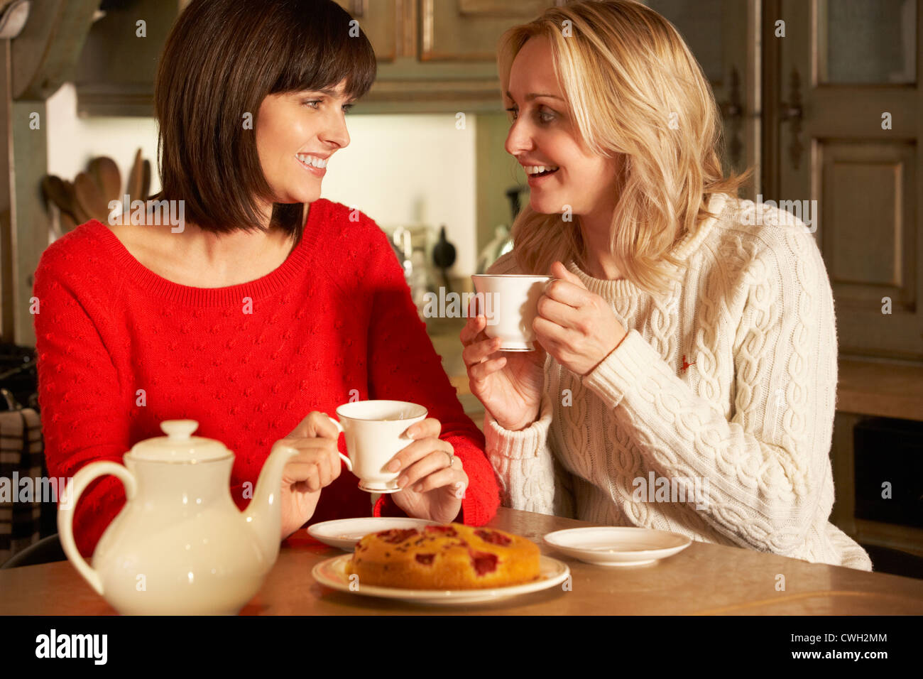 Two Middle Aged Women Enjoying Tea And Cake Together Stock Photo