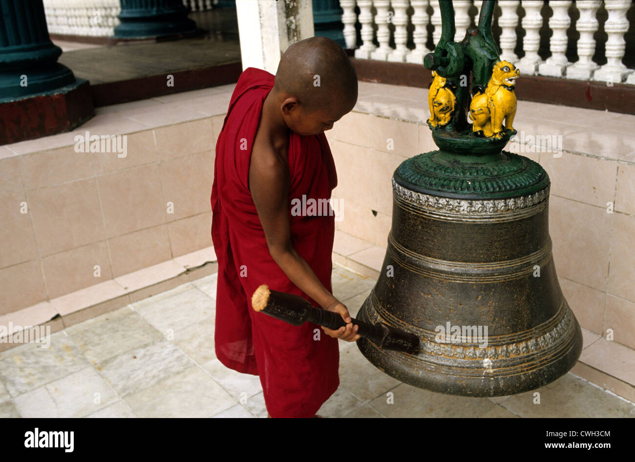 Young monk rings a bell Stock Photo