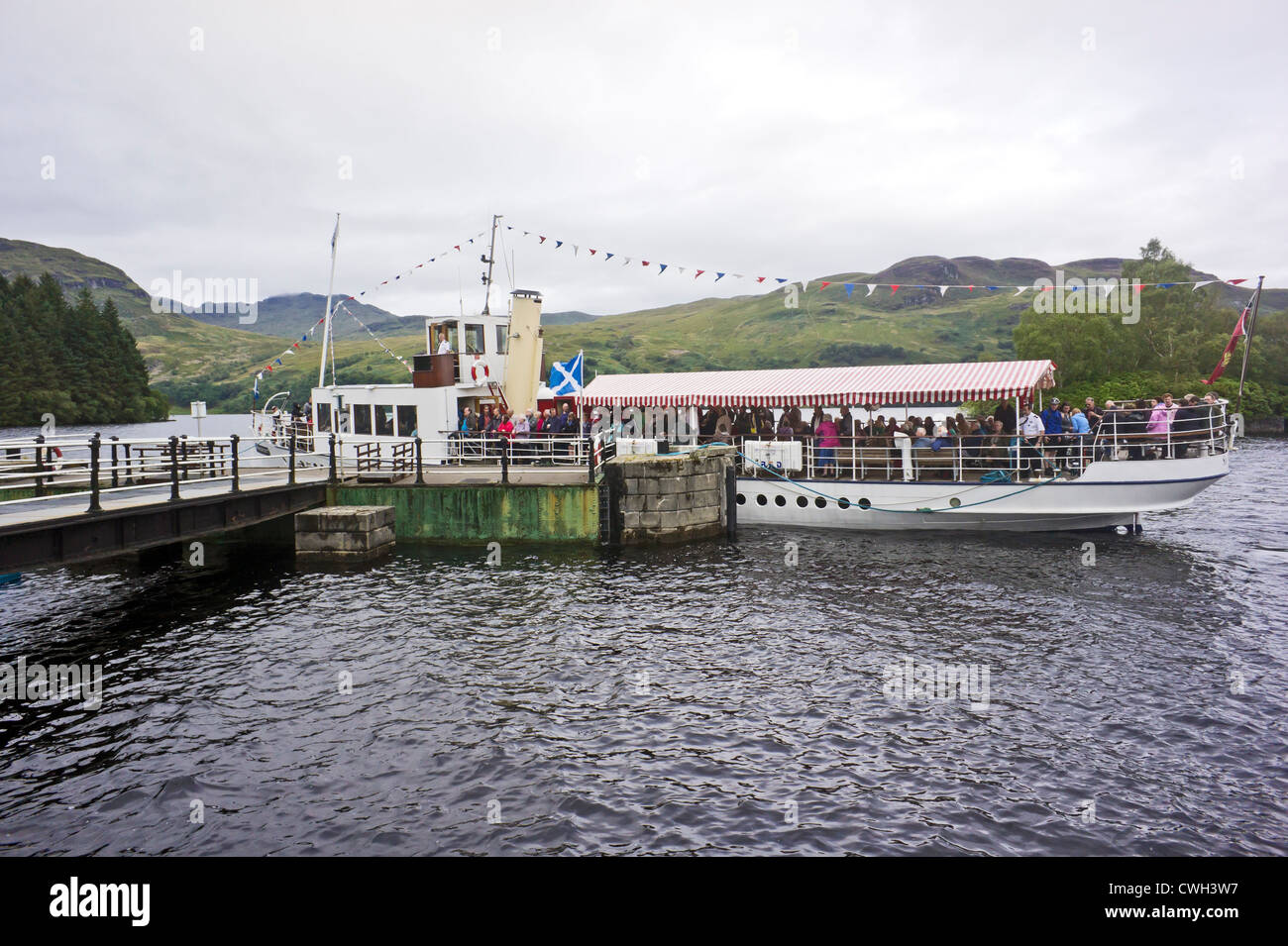 Steamer Sir Walter Scott arriving at Stronachlachar pier at the west end of Loch Katrine from Trossachs Pier in Scotland Stock Photo