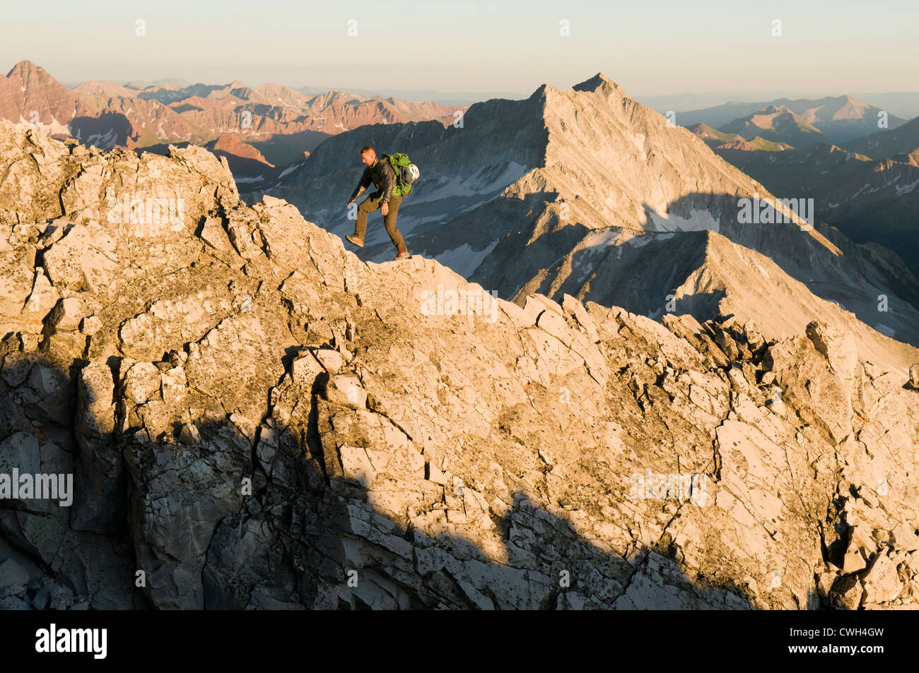 A man hiking along rocky ridge in the White River National Forest ...