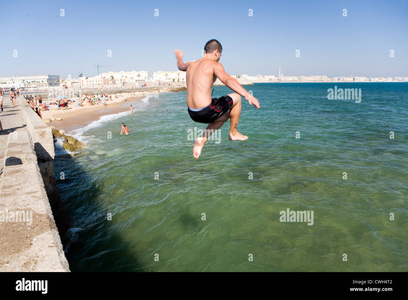 Spain, Cadiz, a boy jumps into the water Stock Photo