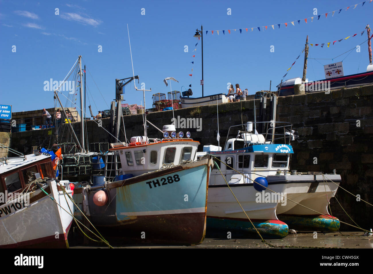 Fishing Boats moored at Low Tide at Newquay Harbour Stock Photo