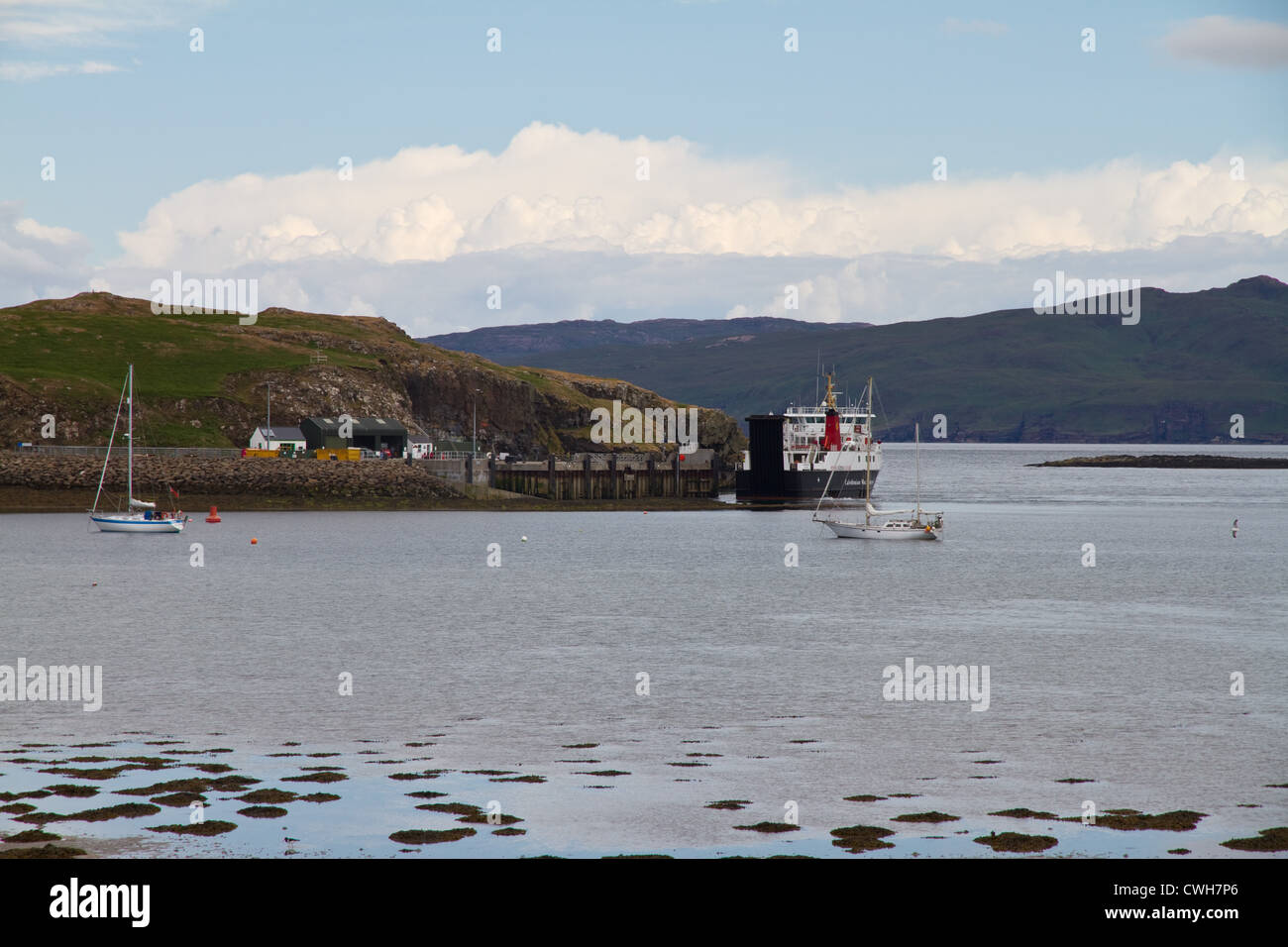 The CalMac ferry arrives at the pier on Isle of Canna, Small Isles, Scotland Stock Photo