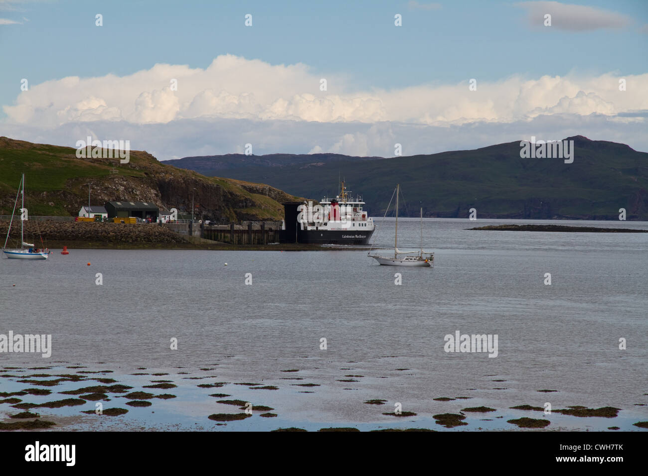 The CalMac ferry arrives at the pier on Isle of Canna, Small Isles, Scotland Stock Photo