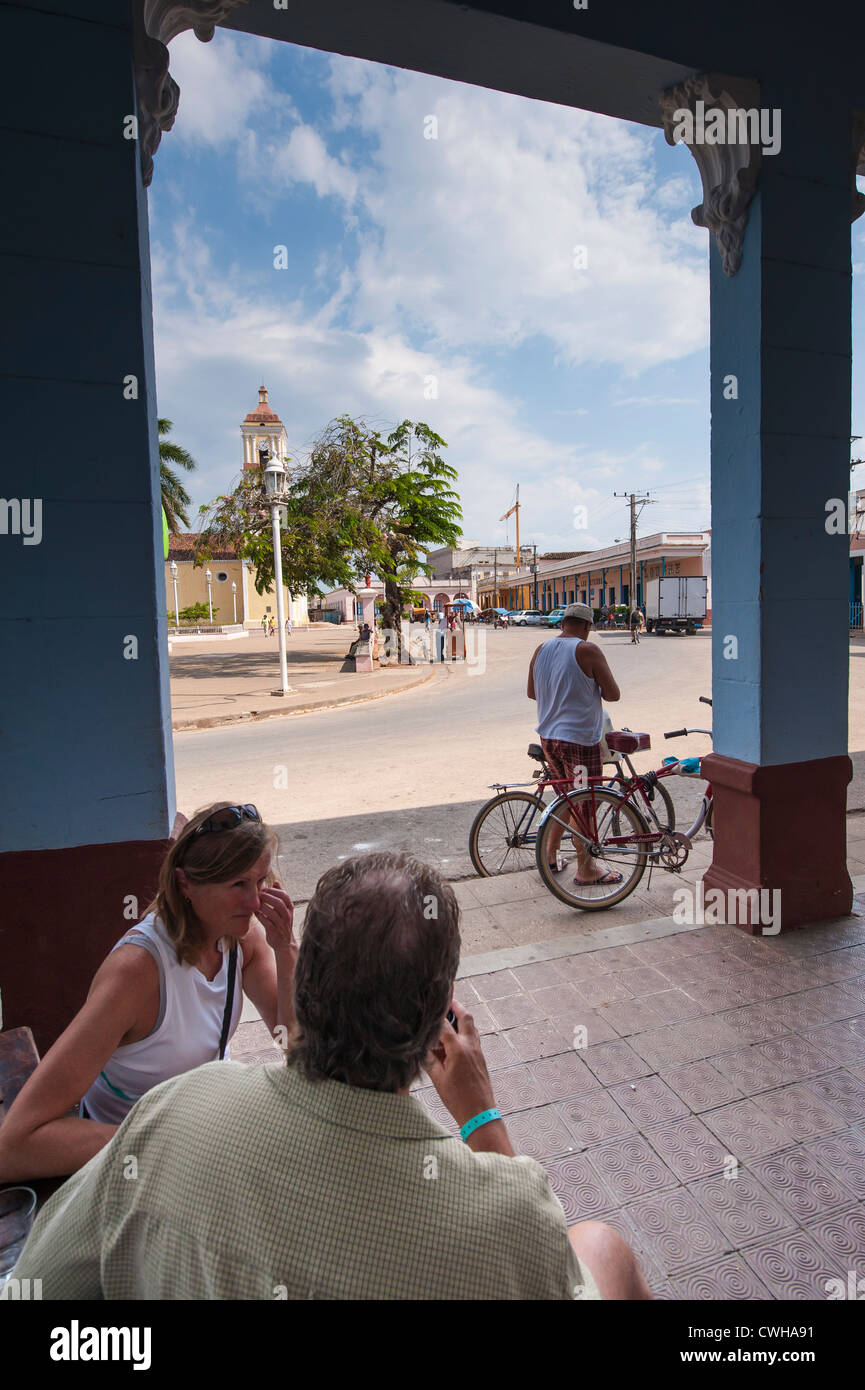 People at a cafe near Iglesia Mayor de San Juan Bautista church in Remedios, Cuba. Stock Photo