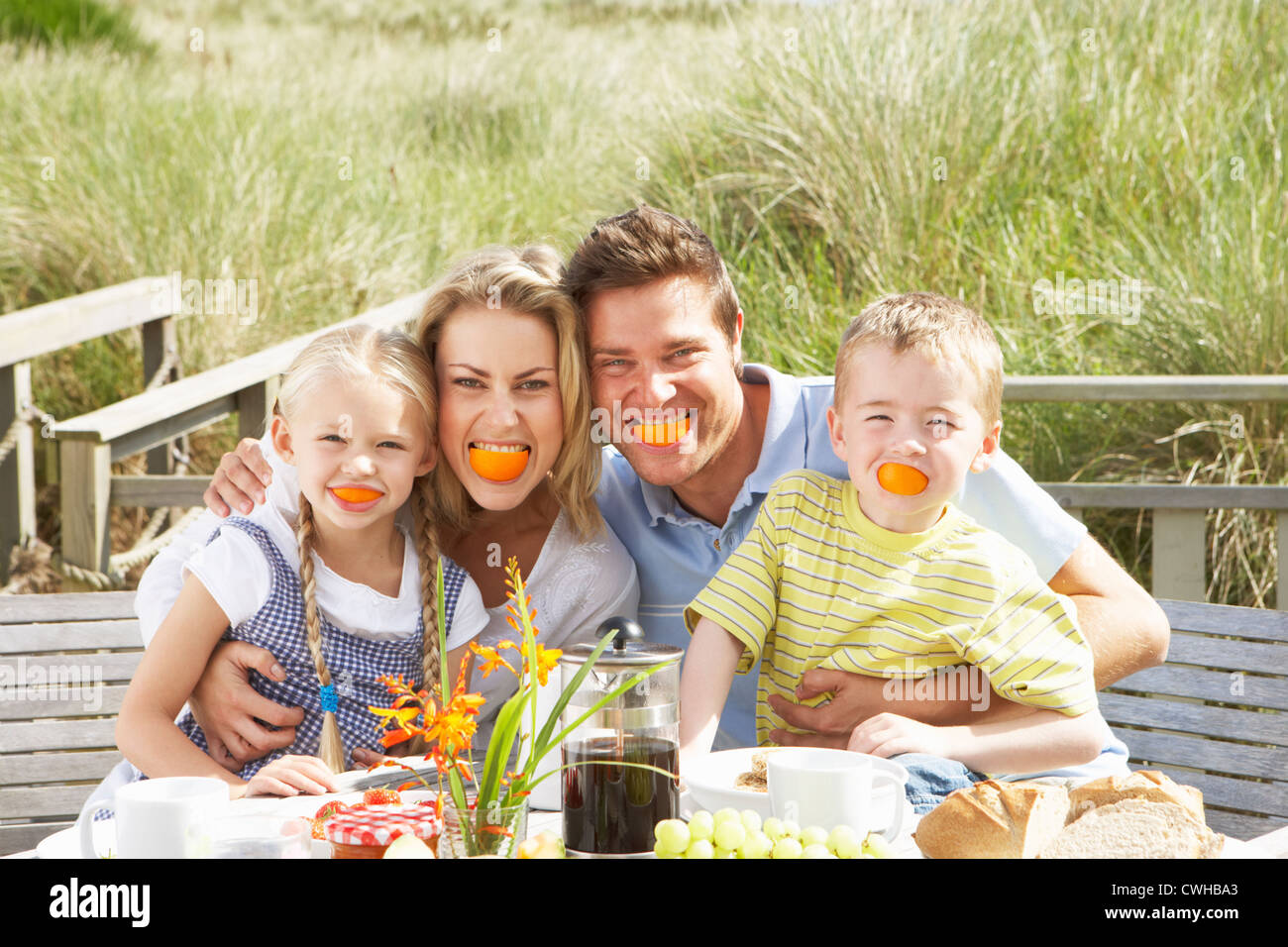 Family on vacation eating outdoors Stock Photo