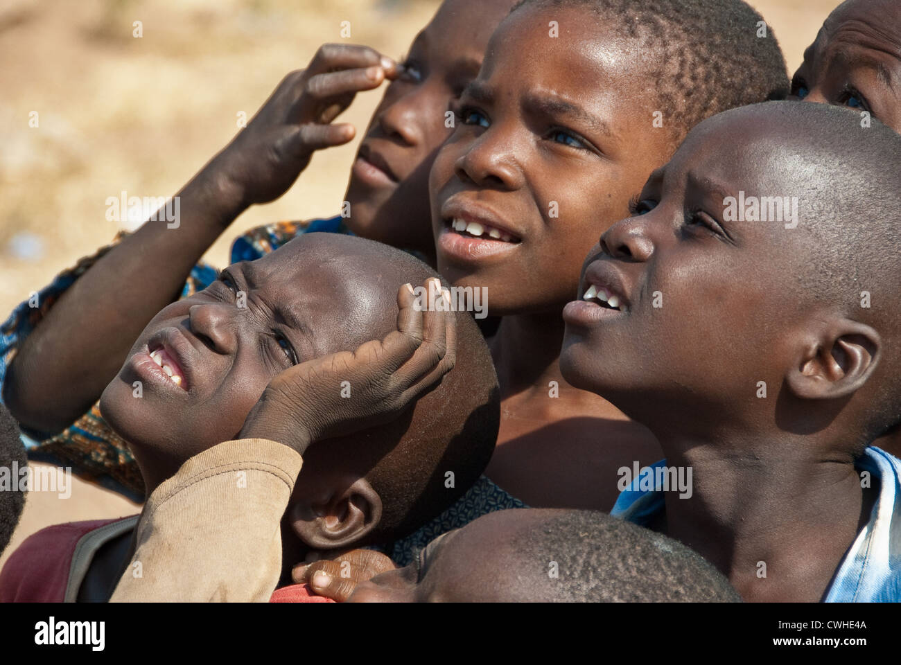 Togolese children intently looking Stock Photo - Alamy