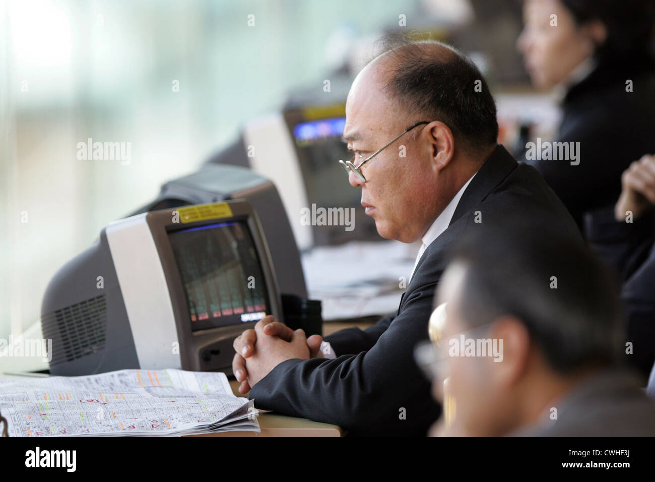 Seoul Racecourse visitors sit in front of monitors in the betting hall Stock Photo