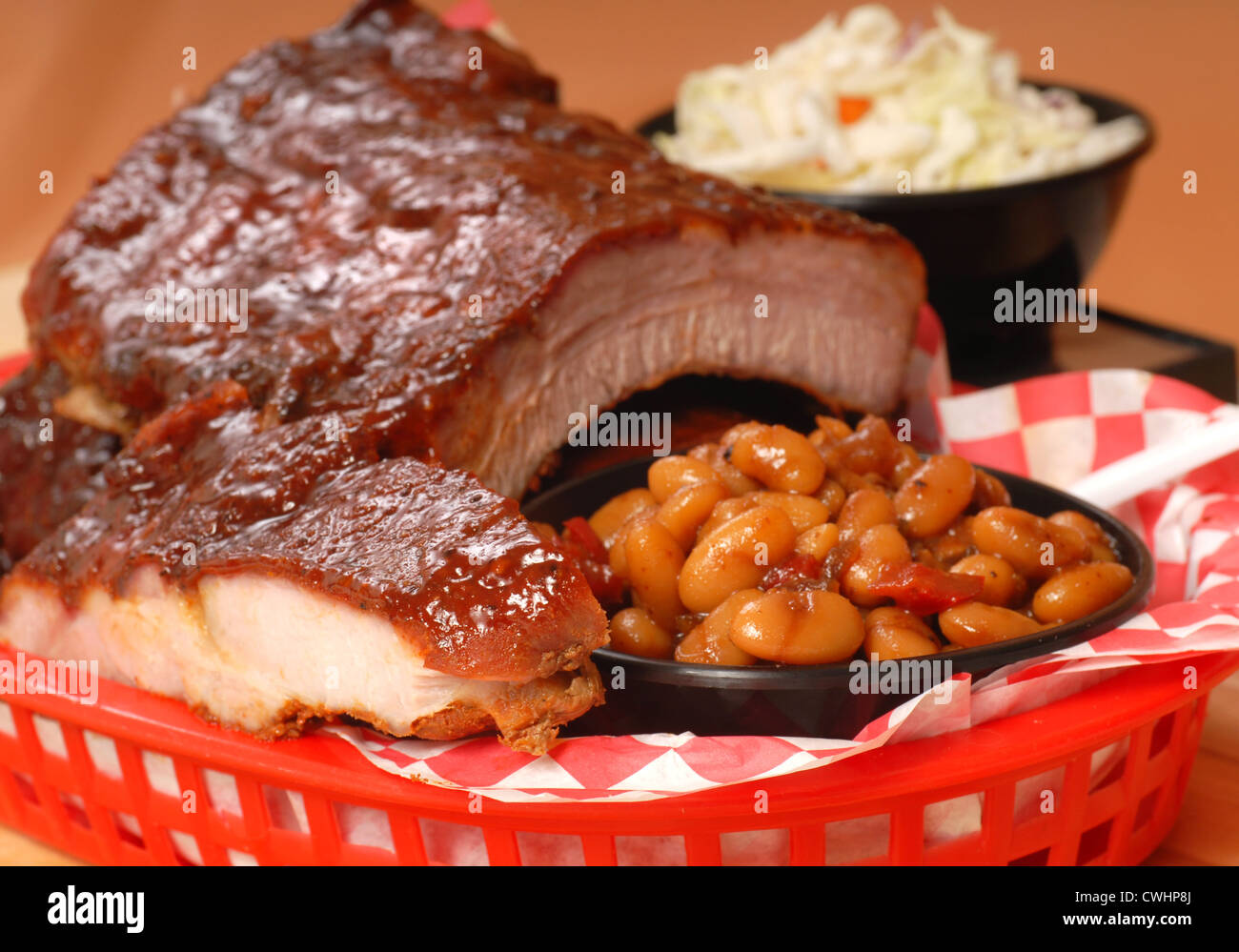 Delicious BBQ ribs with beans, cole slaw and a tangy BBQ sauce Stock Photo