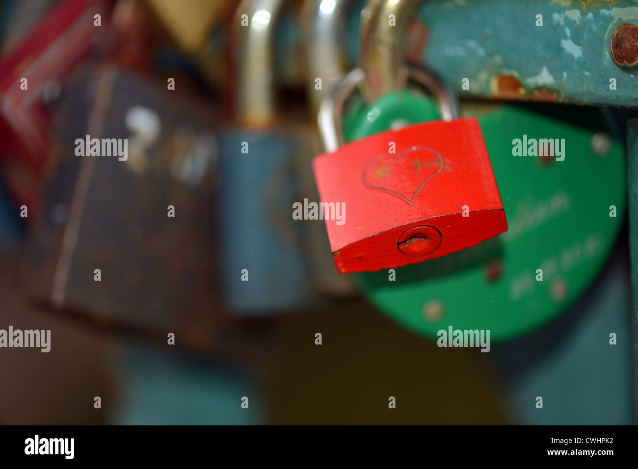 Red padlock with heart among the others on the bridge Stock Photo - Alamy