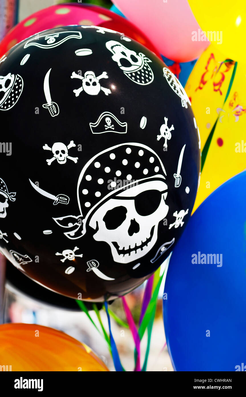 Closeup of a colorful balloon bouquet featuring a pirate balloon. Stock Photo