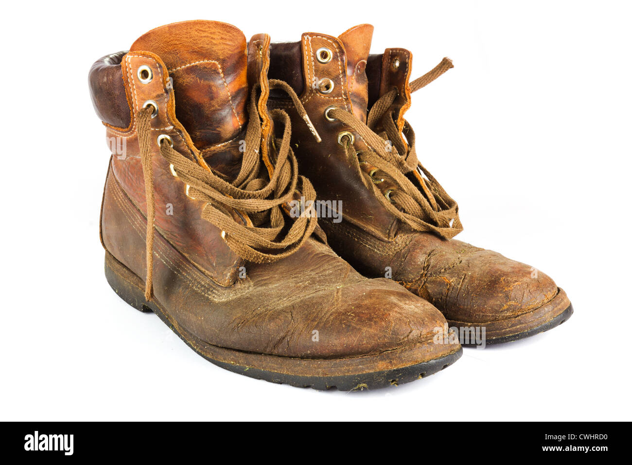 Pair of old worn brown leather work boots on white Stock Photo