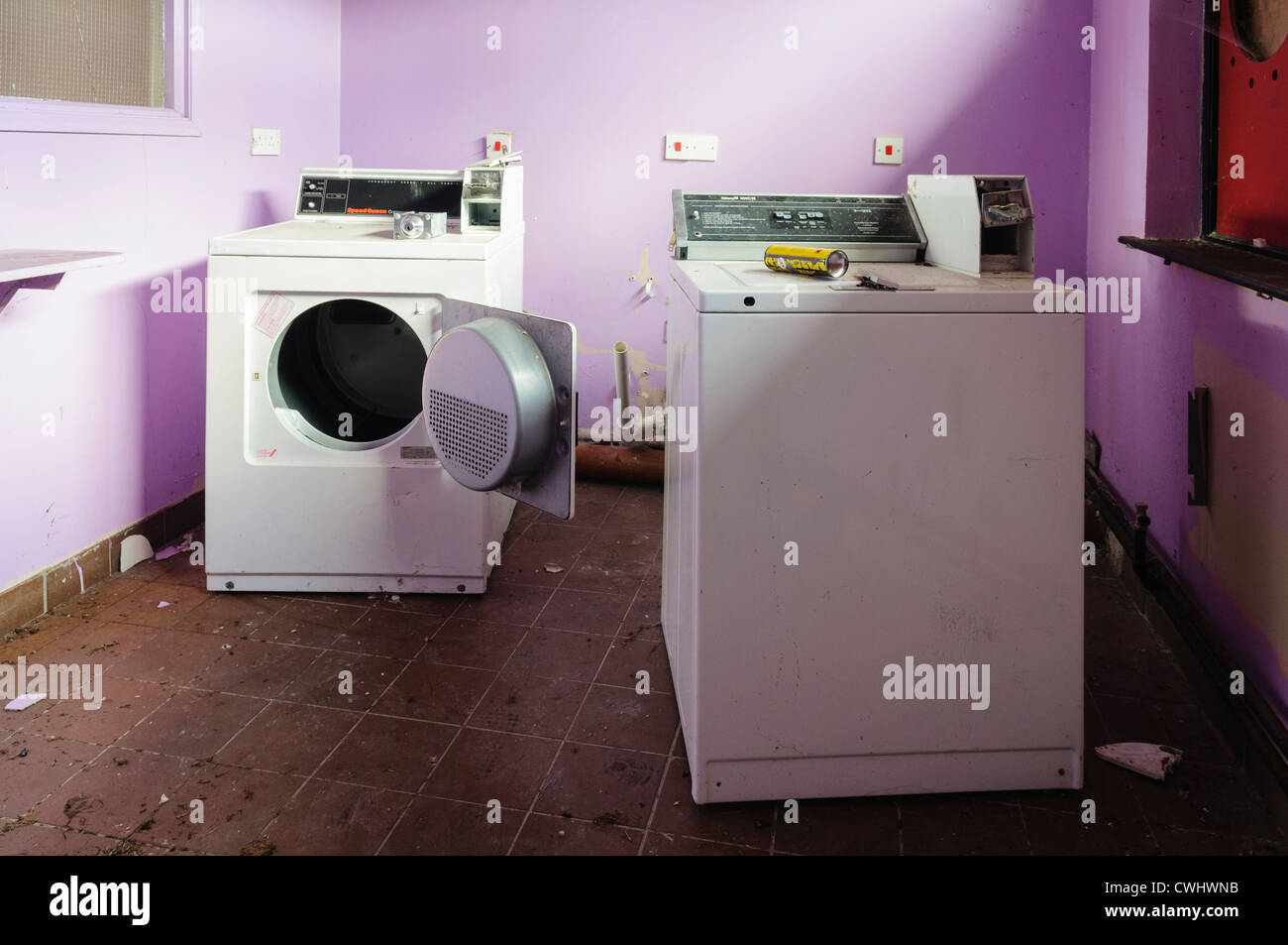 Washing machine and tumble drier in the laundry room of an abandoned B&B house hotel Stock Photo