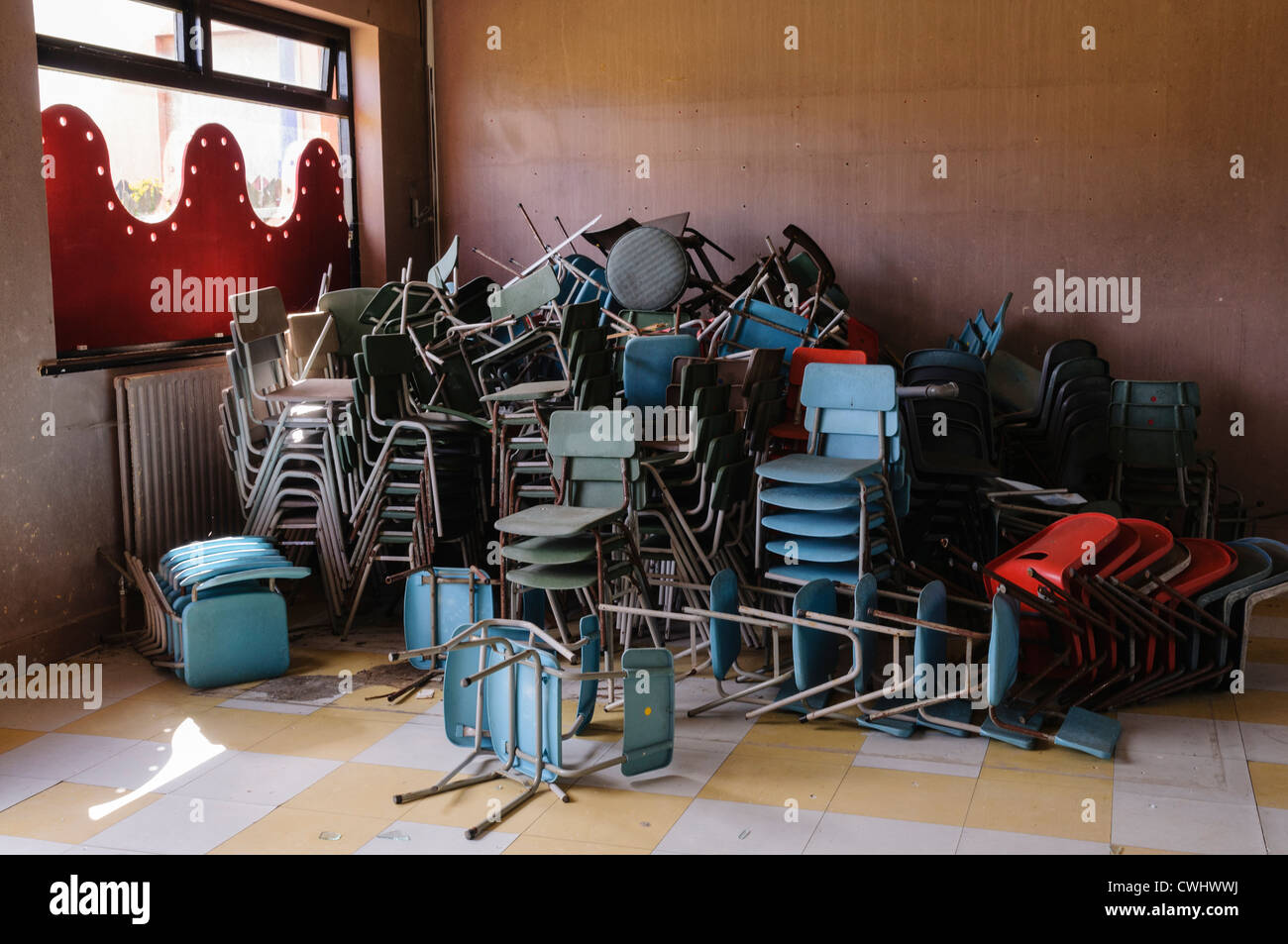 Chairs stacked up in an old school hall Stock Photo Alamy