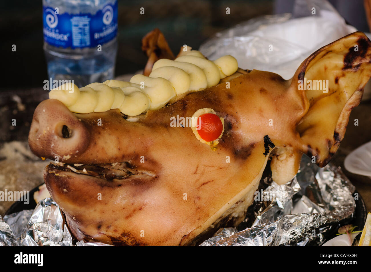A roast pig's head with piped mashed potato Stock Photo