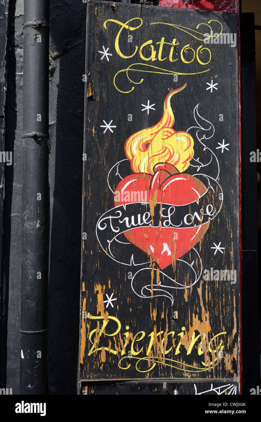 'Tattoo' and 'Piercing' sign outside a shop, London, England Stock