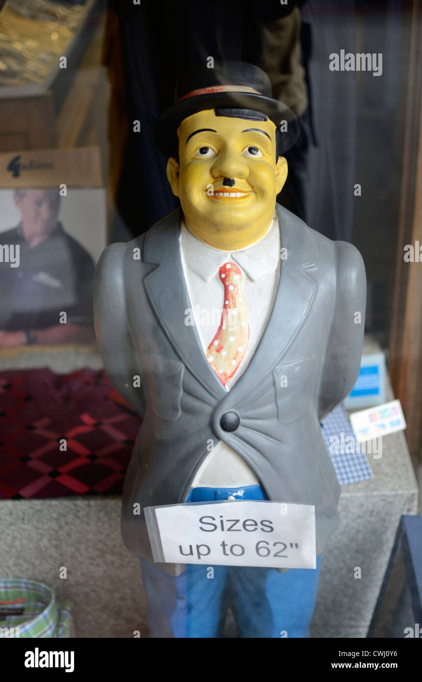 Model of a man in an oversized clothes shop window, London, England Stock Photo