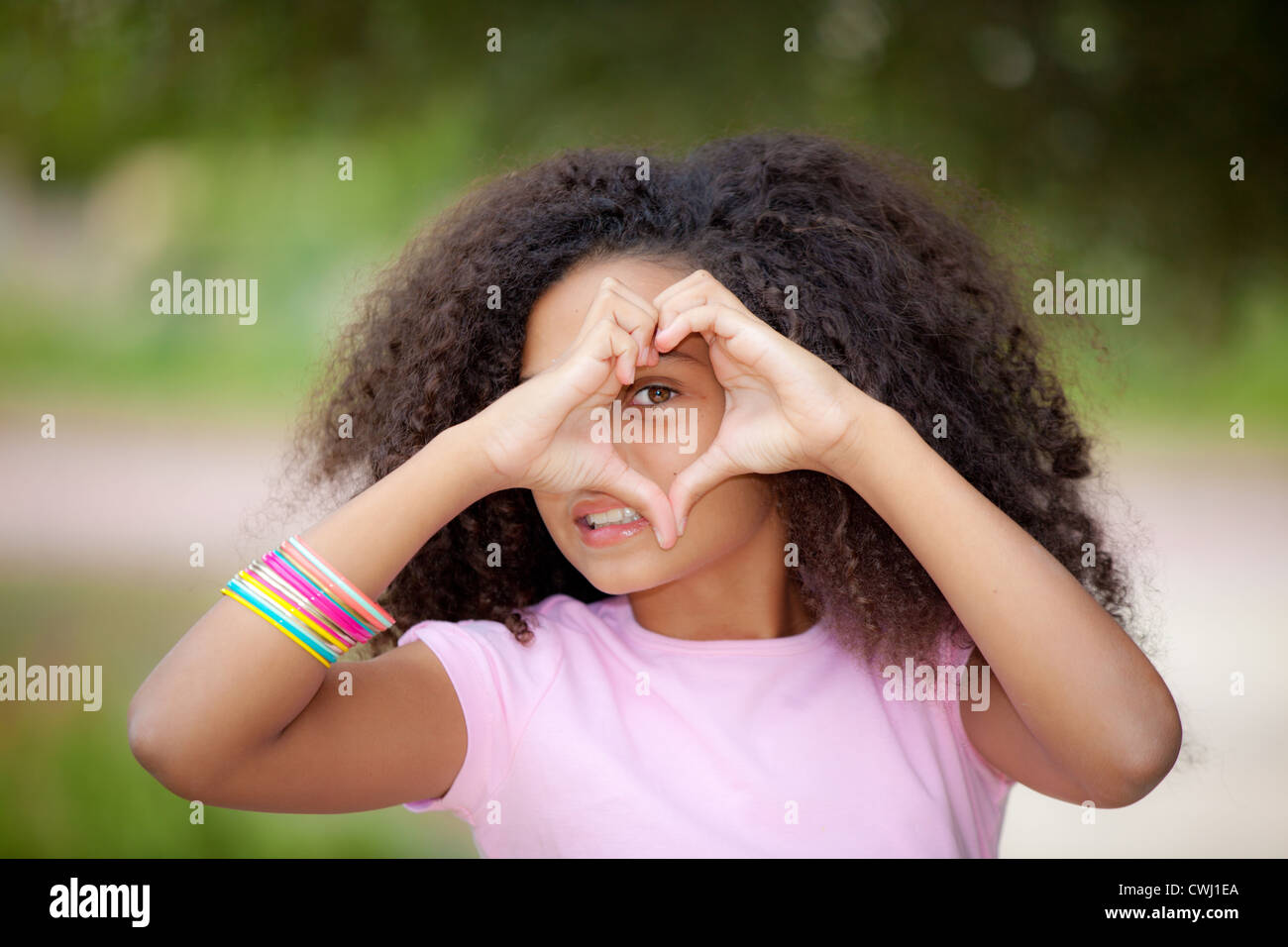 Young African American Kid Making Heart Shape With Hands Stock