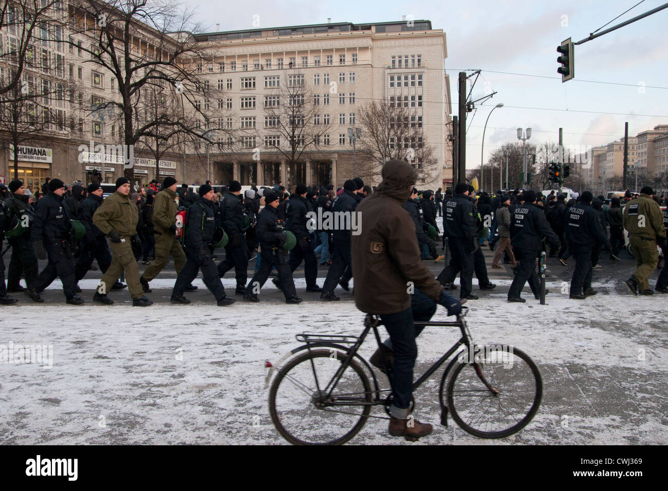 Police squad and a man on a bike. Berlin, Germany. Stock Photo