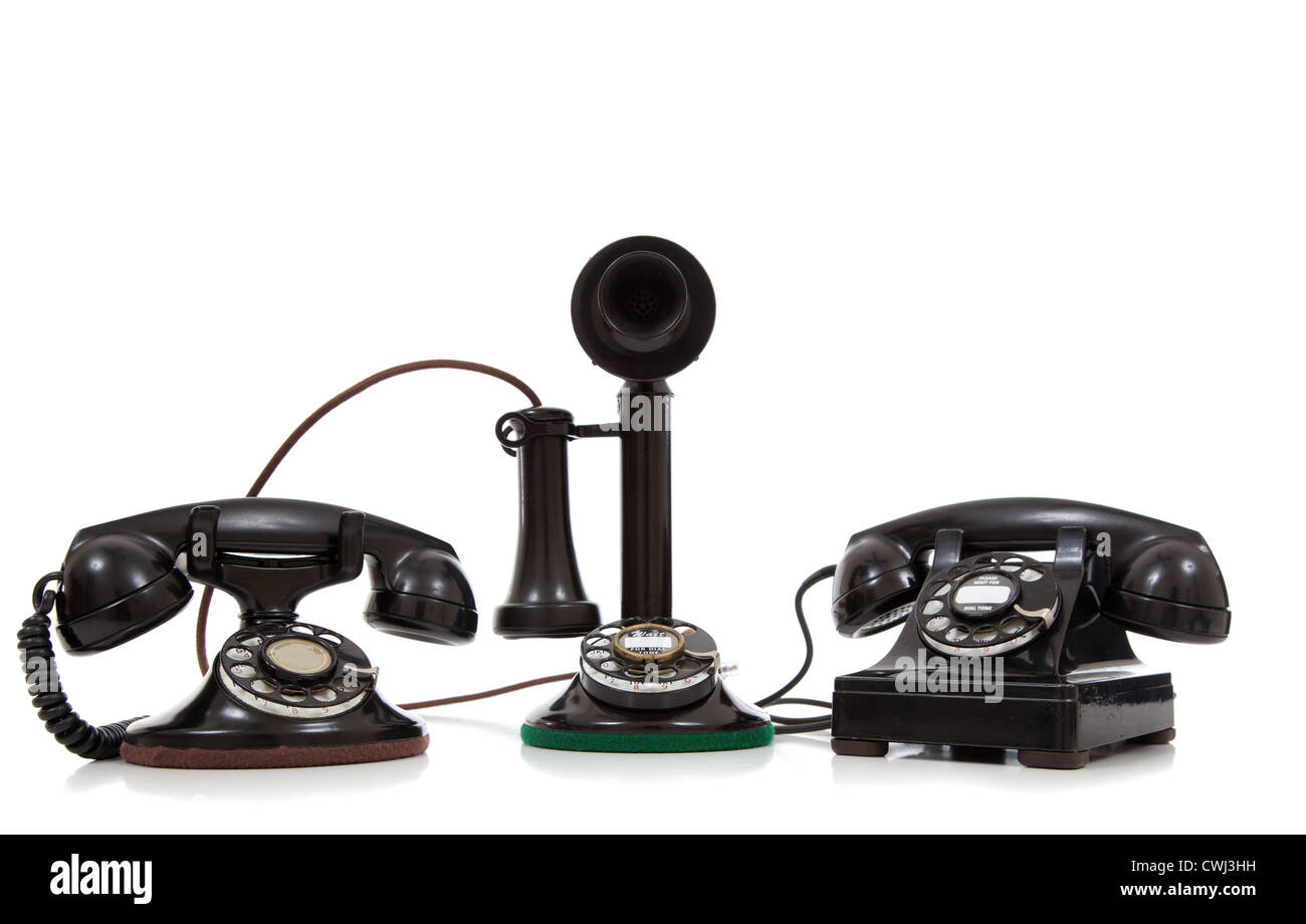 A group of vintage telephones on a white background Stock Photo