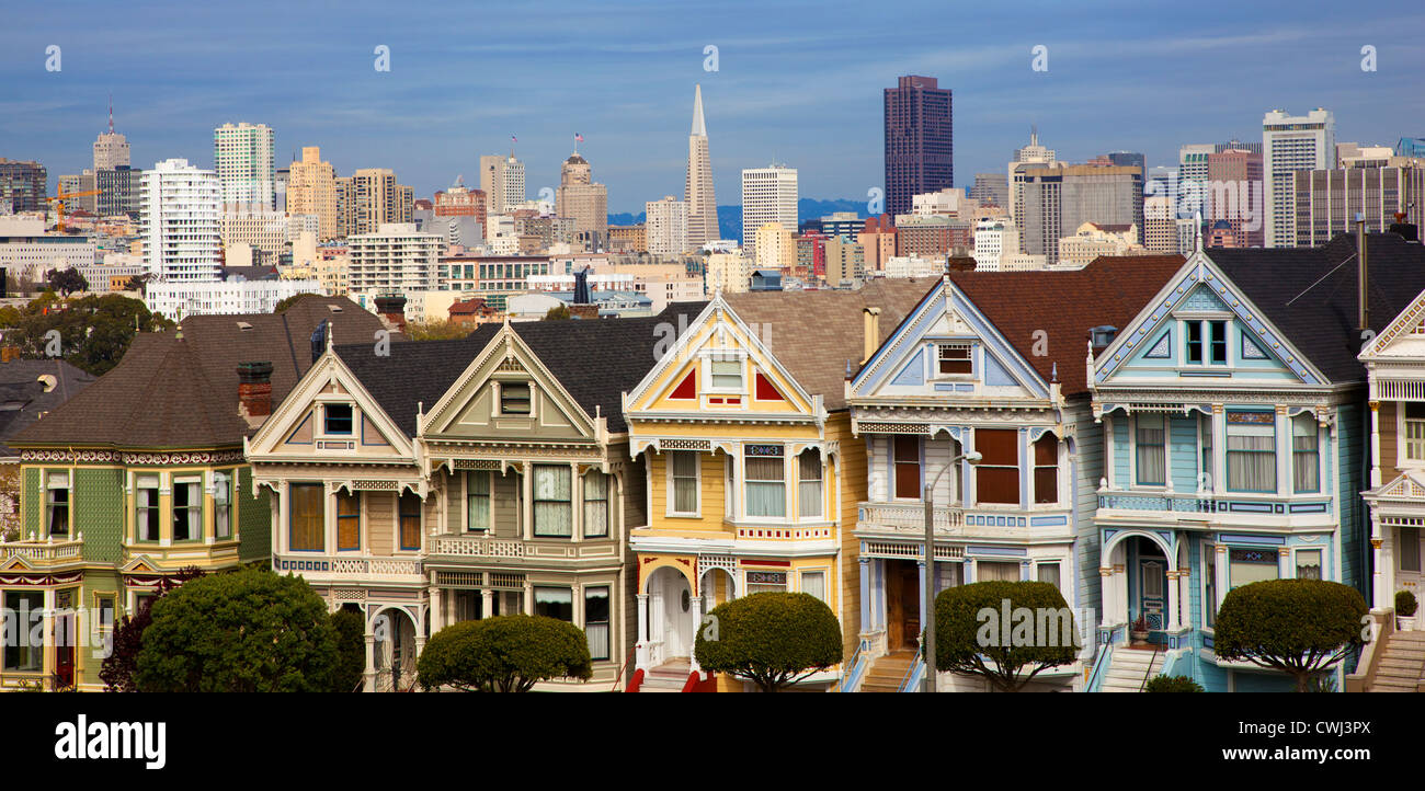 Famous Victorian row houses in San Francisco with skyline. Houses referred to as the painted ladies Stock Photo