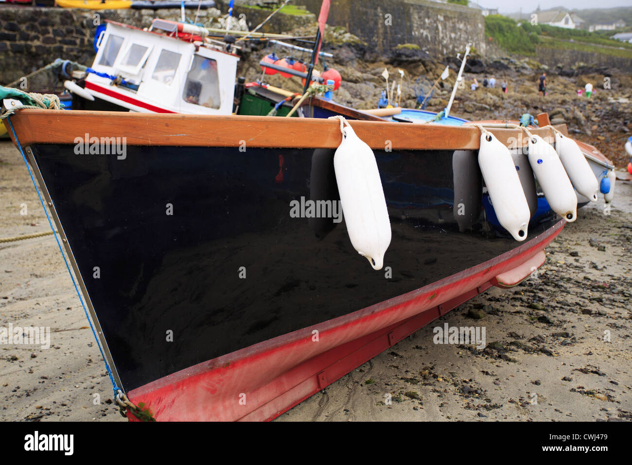 Fishing boats and fenders in dry harbour Stock Photo Alamy
