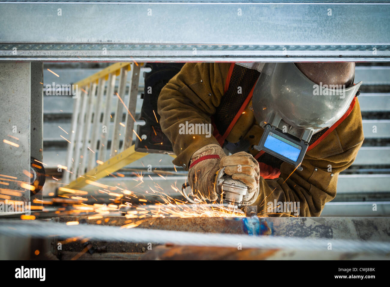 Construction worker grinding metal Stock Photo