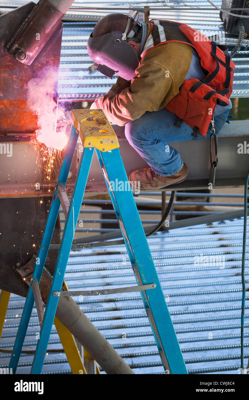 Construction worker welding metal Stock Photo