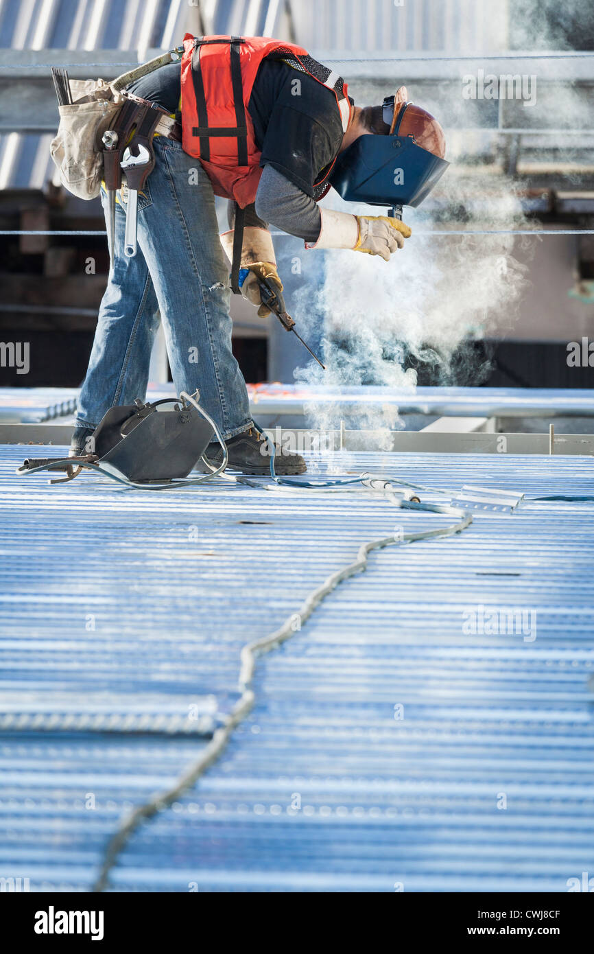 Caucasian construction worker welding floor Stock Photo