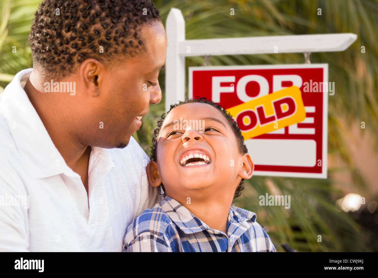 Happy African American Father and Mixed Race Son in Front of Sold Real ...