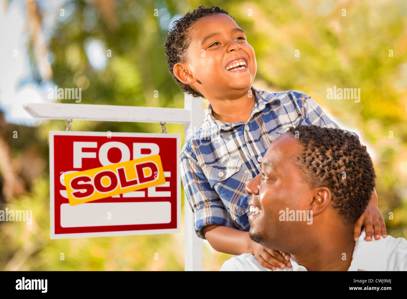 Happy African American Father and Mixed Race Son in Front of Sold Real ...