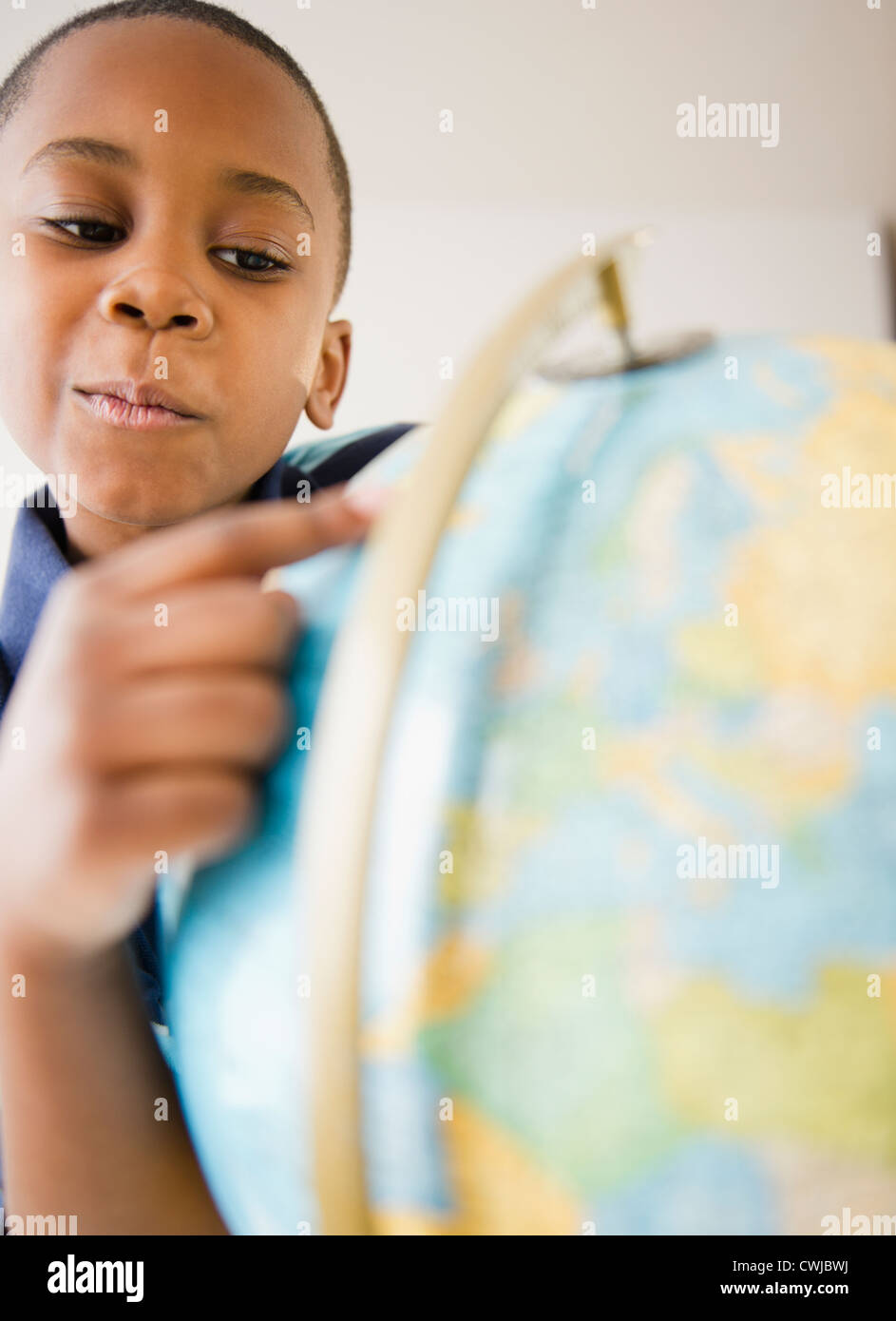 Black boy looking at globe Stock Photo