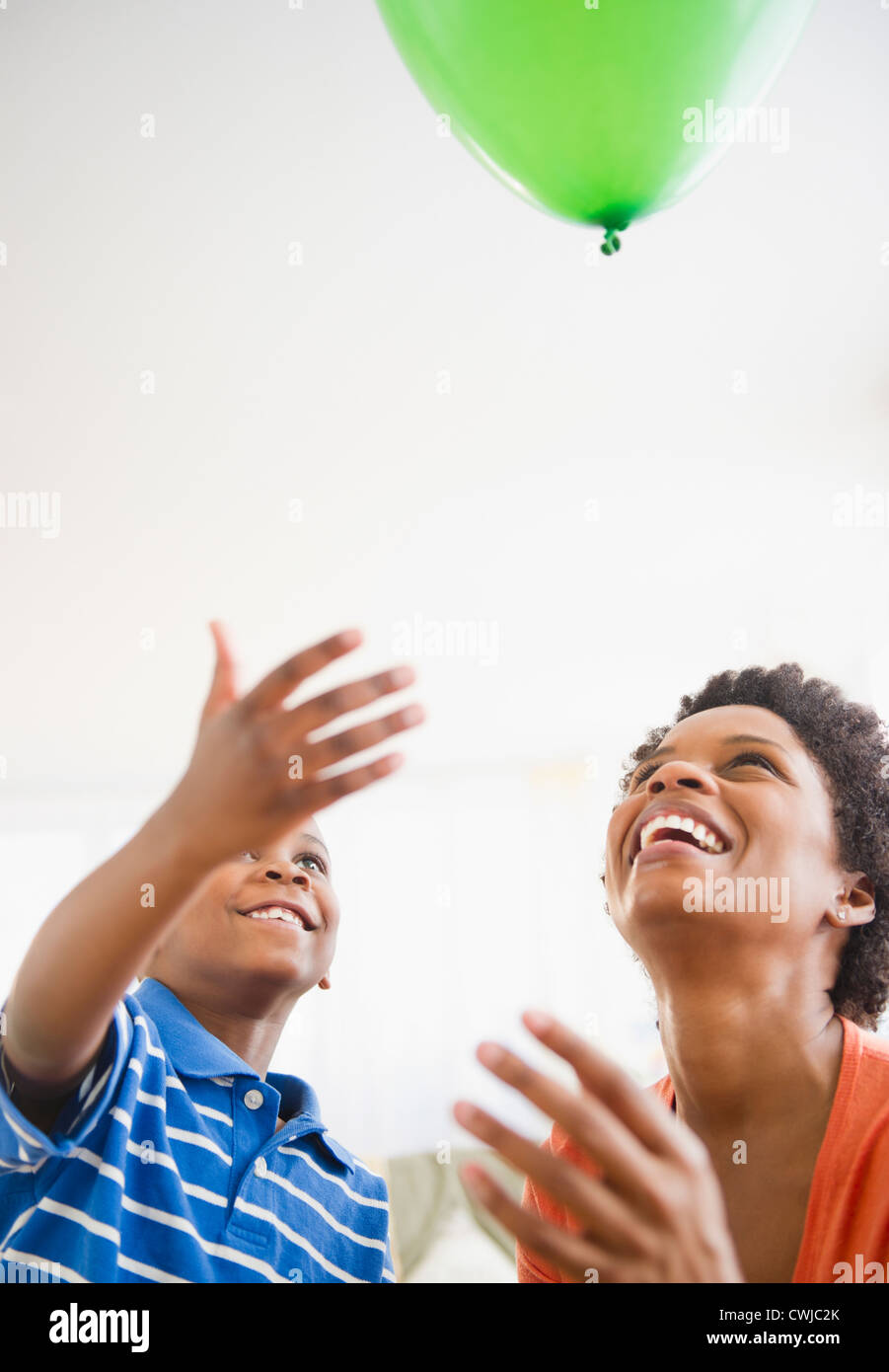 Black mother and son watching floating balloon Stock Photo